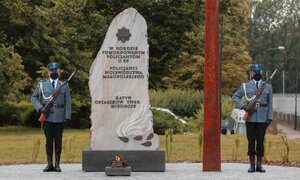 Obelisk na terenie komendy i dwóch policjantów pełniących wartę honorową