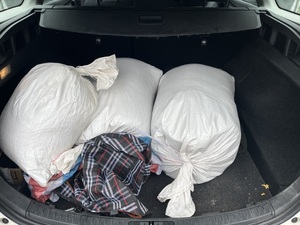 trzy worki parciane białe wypełnione krajanką tytoniu, leżące w bagażniku pojazdu