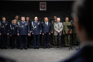 Pierwszy szereg umundurowanych policjantów, obok wojewoda małopolski, prezydent miasta Krakowa, drugi szereg umundurowani przedstawiciele innych służb mundurowych.