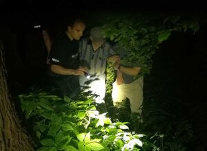 policjant wraz z drugim mężczyzną prowadzący schorowanego zaginionego seniora