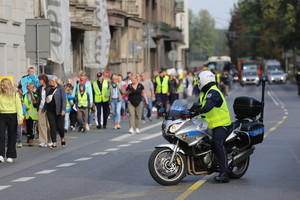 policyjny motocyklista zabezpiecza pochód dzieci