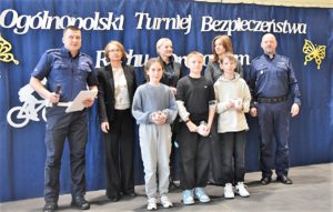 Uczniowie z nagrodami oraz Komendant Powiatowy Policji w Bochni, Naczelnik WYdziału Ruchu Drogowego