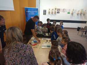 Technik kryminalistyki prezentuje walizkę daktyloskopij i zabezpiecza ślady