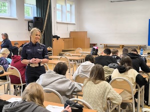 policjantka podczas pisania przez uczniów testu ze znajomości zasad ruchu drogowego