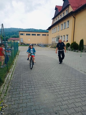 policjant przyglądający się uczniowi podczas egzaminu