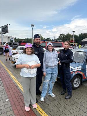 umundurowany policjant i policjantka z dwójką dziewcząt