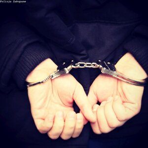dłonie  trzymanego w kajdankach