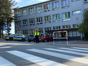 dzielnicowy w rejonie przejścia dla pieszych przy szkole