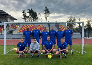 drużyna KPP w Krakowie, mężczyźni w strojach sportowych pozują do zdjęcia w bramce