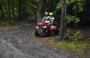 Strażacy na quadzie, poruszający się na terenie leśnym