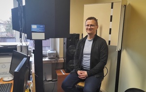 Aktor Piotr Struczyk na krześle na który wykonywana jest fotografia analityczna