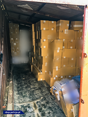 Brązowe kartony z papierosami w blaszanym garażu