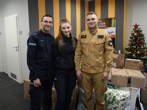 dwoje policjantów oraz strażak przy choince