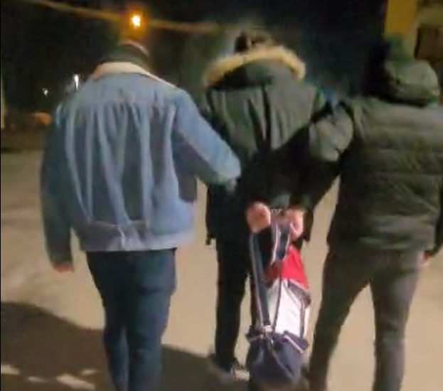 policjanci prowadzą zatrzymanego mężczyznę