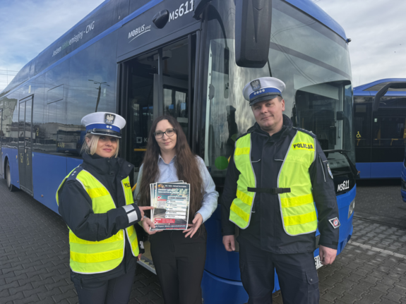 Policjanci drogówki stoją z kierujacą autobusem