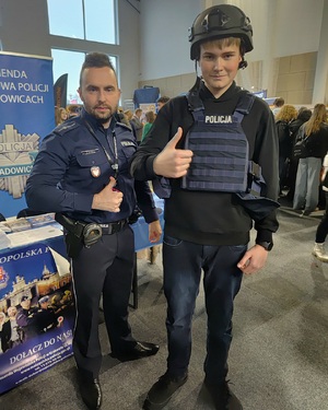 Policjant i chłopak ubrany w elementy umundurowania policyjnego