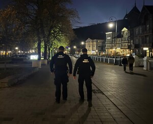 noc, dwóch umundurowanych funkcjonariuszy patroluje miasto