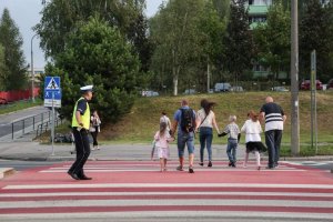 policjant ruchu drogowego na pasach dba o bezpieczeństwo pieszych