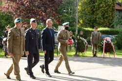 Przedstawiciele służb podchodzą do pomnika