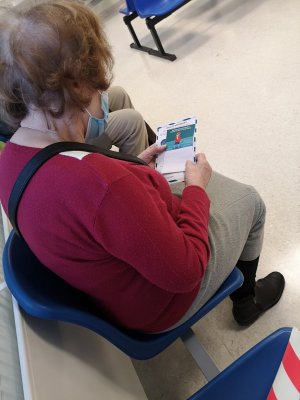 Starsza kobieta patrzy na ulotki