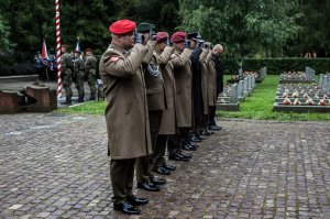 Dowództwo. Żołnierze salutują przed pomnikiem