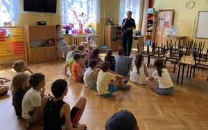 dzieci podczas spotkania słuchające prelekcji prowadzonej przez policjantkę