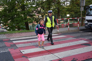 policjant przechodzi z dzieckiem prez pasy