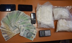 zabezpieczone narkotyki w przezroczystej torbie foliowej, waga elektroniczna, telefony komórkowe i gotówka