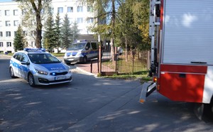 pojazdy służb mundurowych wyjeżdżają z terenu przy oddziale szpitalnym