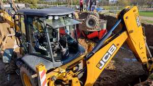 koparka i wywrócone wozidło, w tle radiowóz