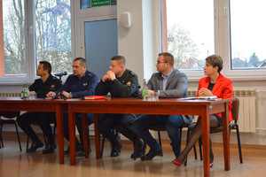 Przedstawiciele służb - straż, policja oraz instytucji siedzą za stołem