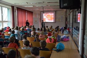 dzieci w sali Miejskiego Ośrodka Kultury w Olkuszu oglądają wyświetlany na ekranie bajkę