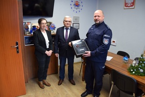 Komendant Powiatowy Policji trzyma promiler, obok stoi Burmistrz Miasta i Skarbnik.
