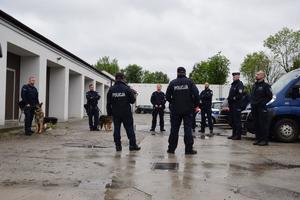 policjanci z psami ustawieni koło garaży komendy wojewódzkiej