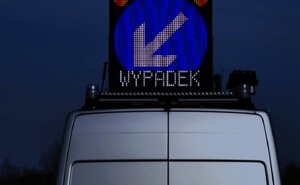 fragment policyjnego radiowozu, na którego dachu znajduje się tablica ledowa z napisem wypadek