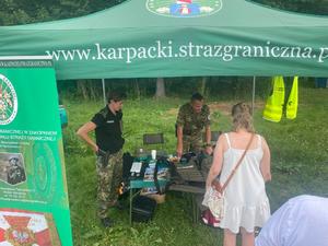 Stoisko Strazy Granicznej i stojące przy nich osoby