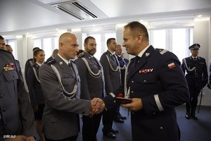 policjant gratuluje odznaczanym policjantów