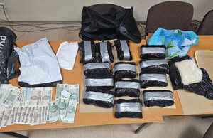 zabezpieczone narkotyki w czarnych foliowych torbach oraz zabezpieczona gotówka